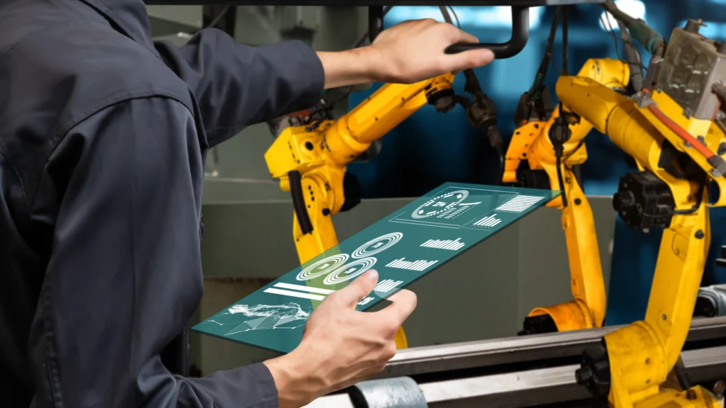Trabajador sostiene maquinaria para manufactura aditiva con una tablet en sus manos.